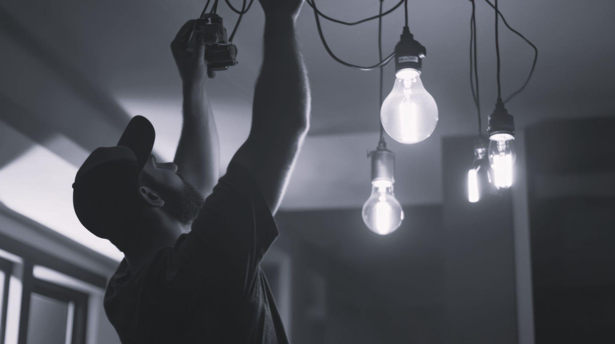 Landlord installing new light in rental property