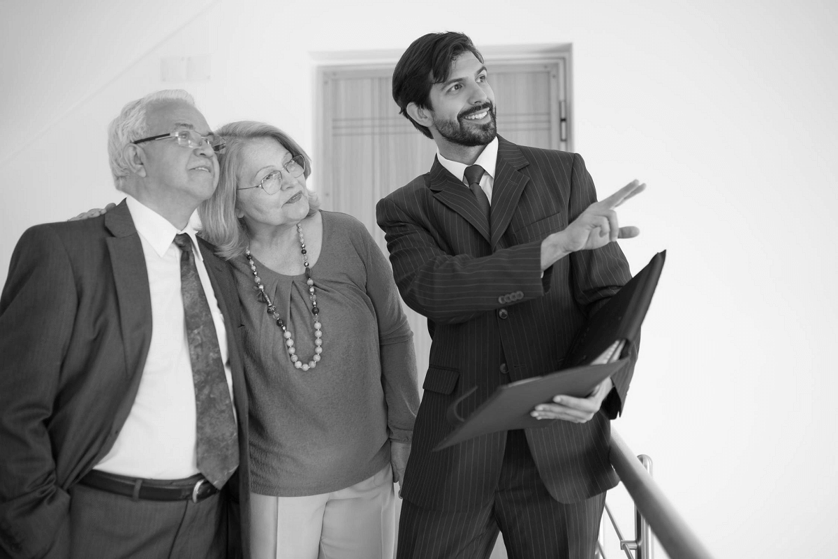 real estate agent showing mature couple a new house real estate agent showing mature couple a new house