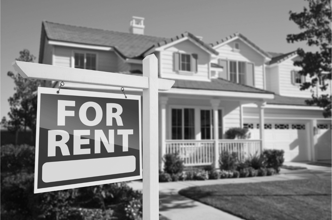 right facing for rent real estate sign in front of house