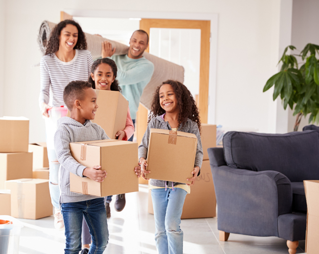 family moving boxies into new home