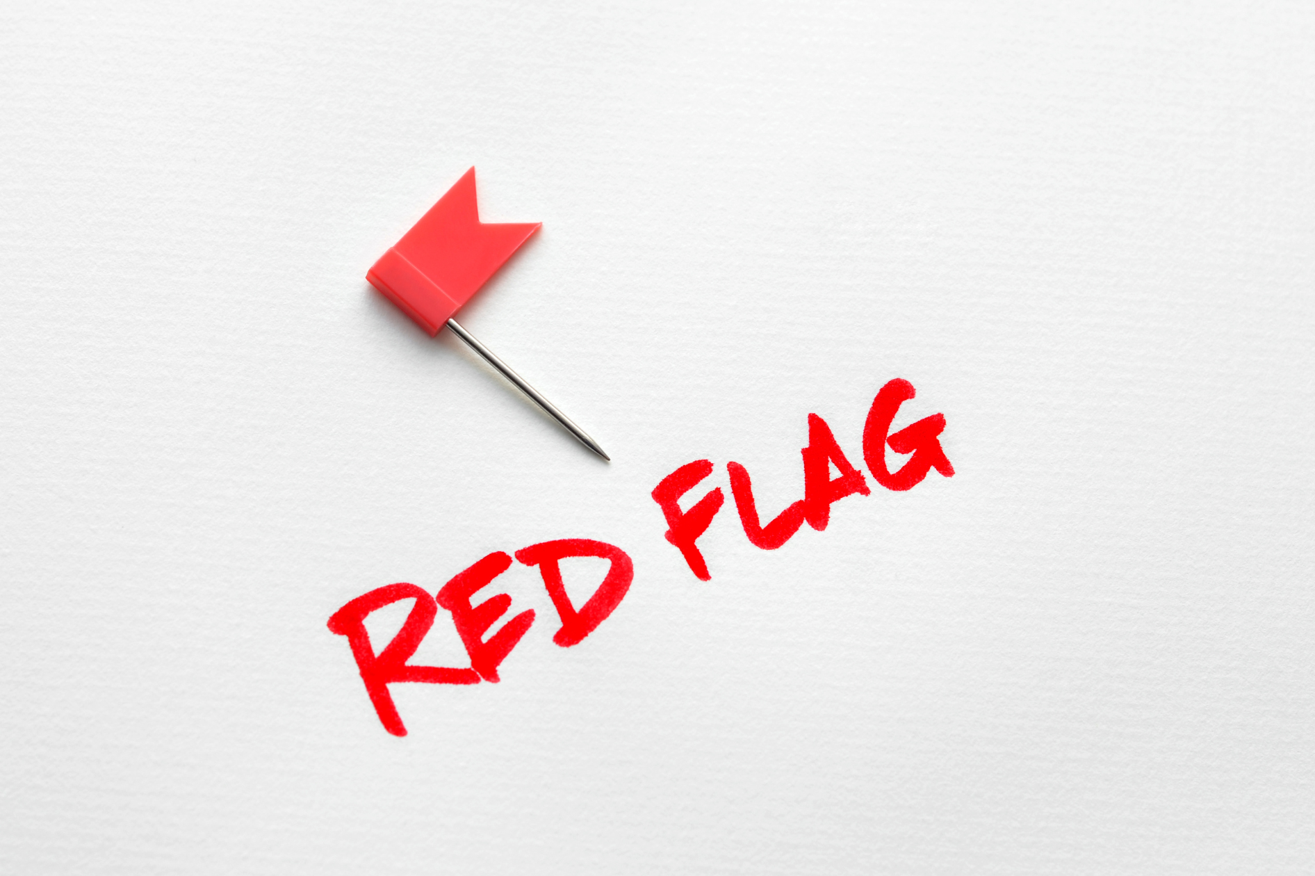 image1 A small red flag on a piece of paper, with "RED FLAG" written in red underneath