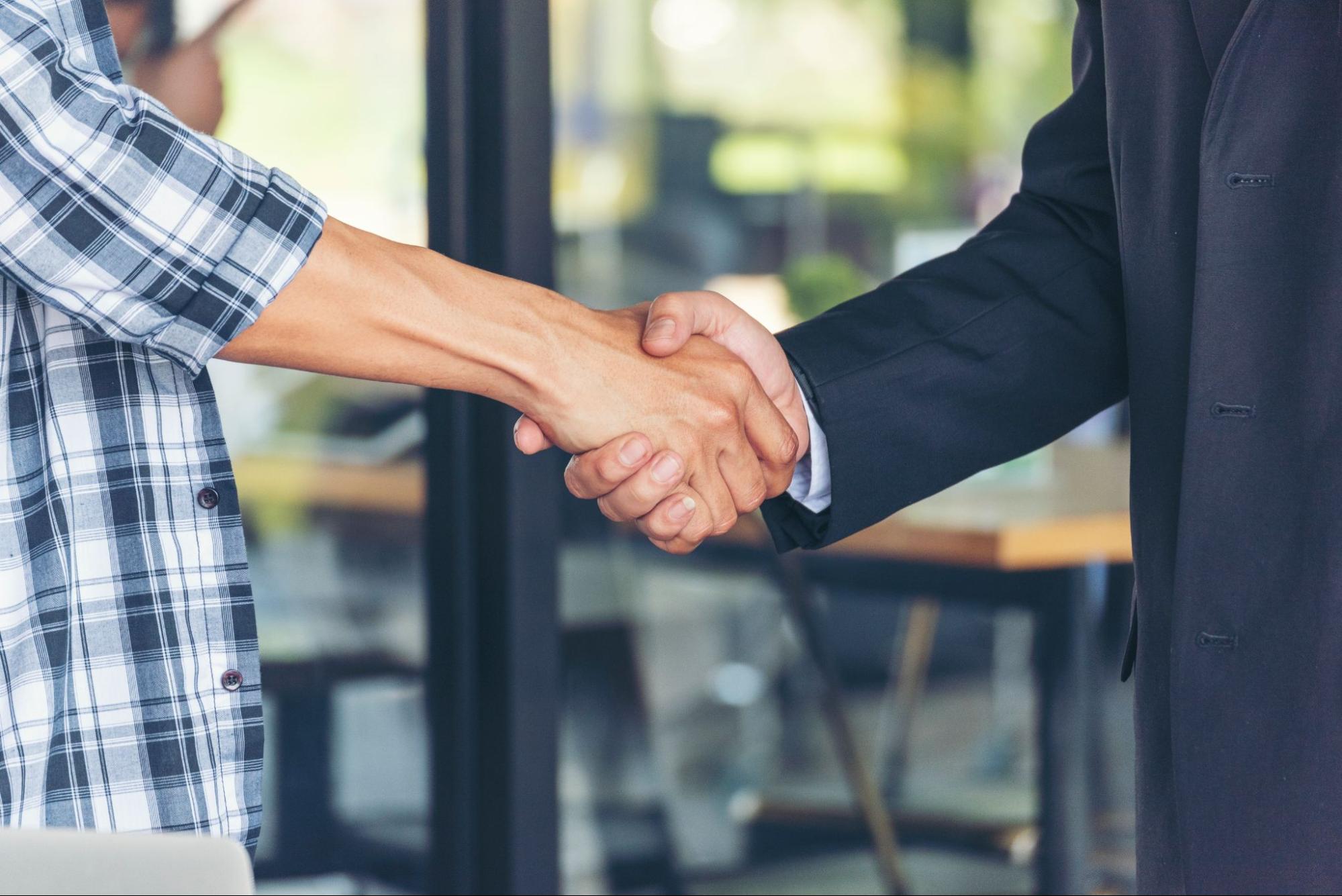 A tenant and a property manager shaking hands