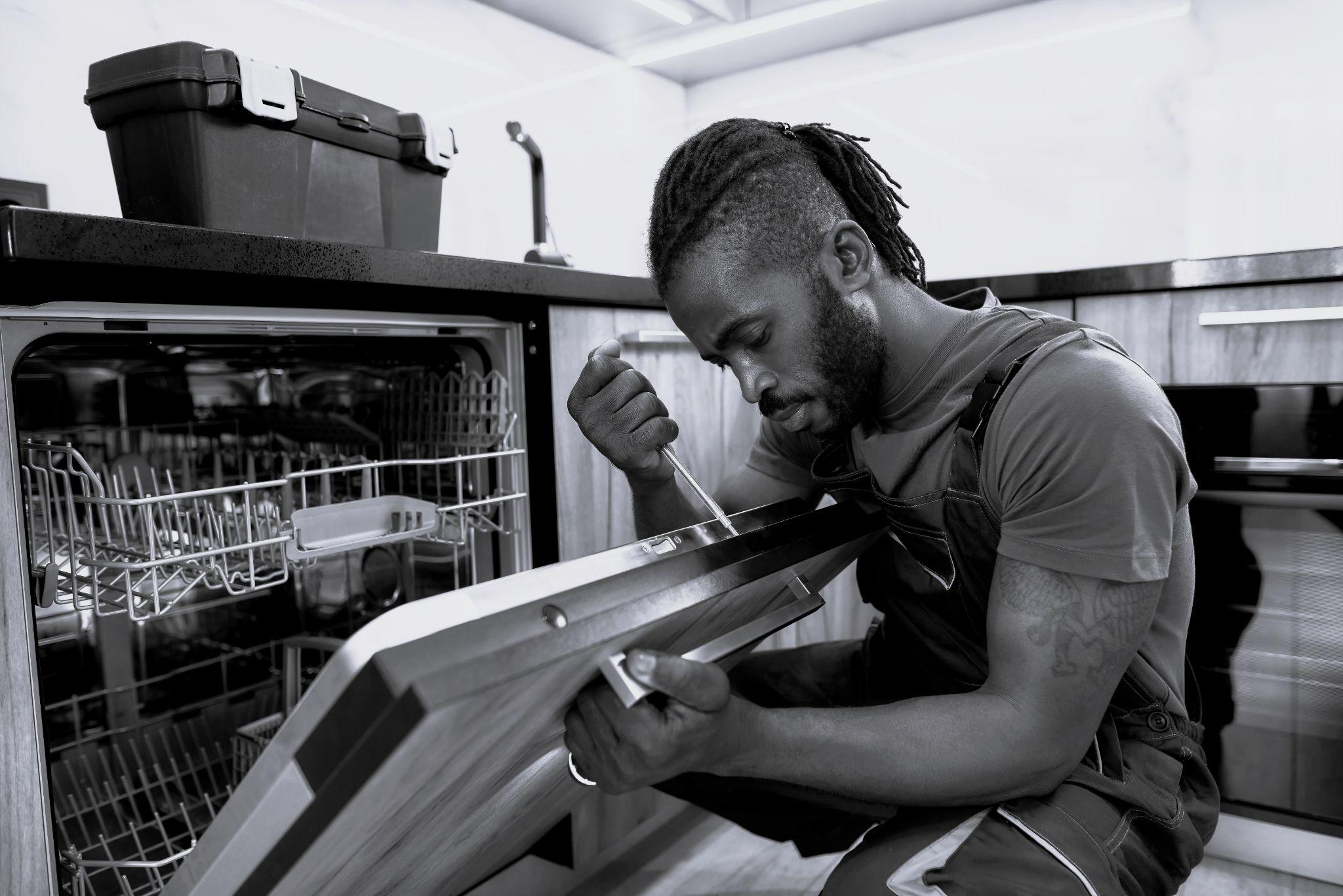 Service man installing washing machine in new appartment