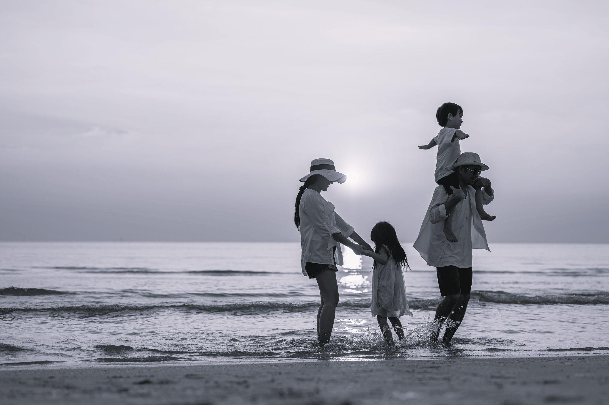 Happy family enjoys beach activities during the summer holidays.