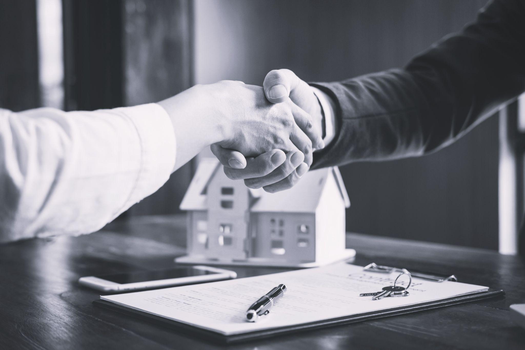 Estate agent and customer shaking hands after finished contract