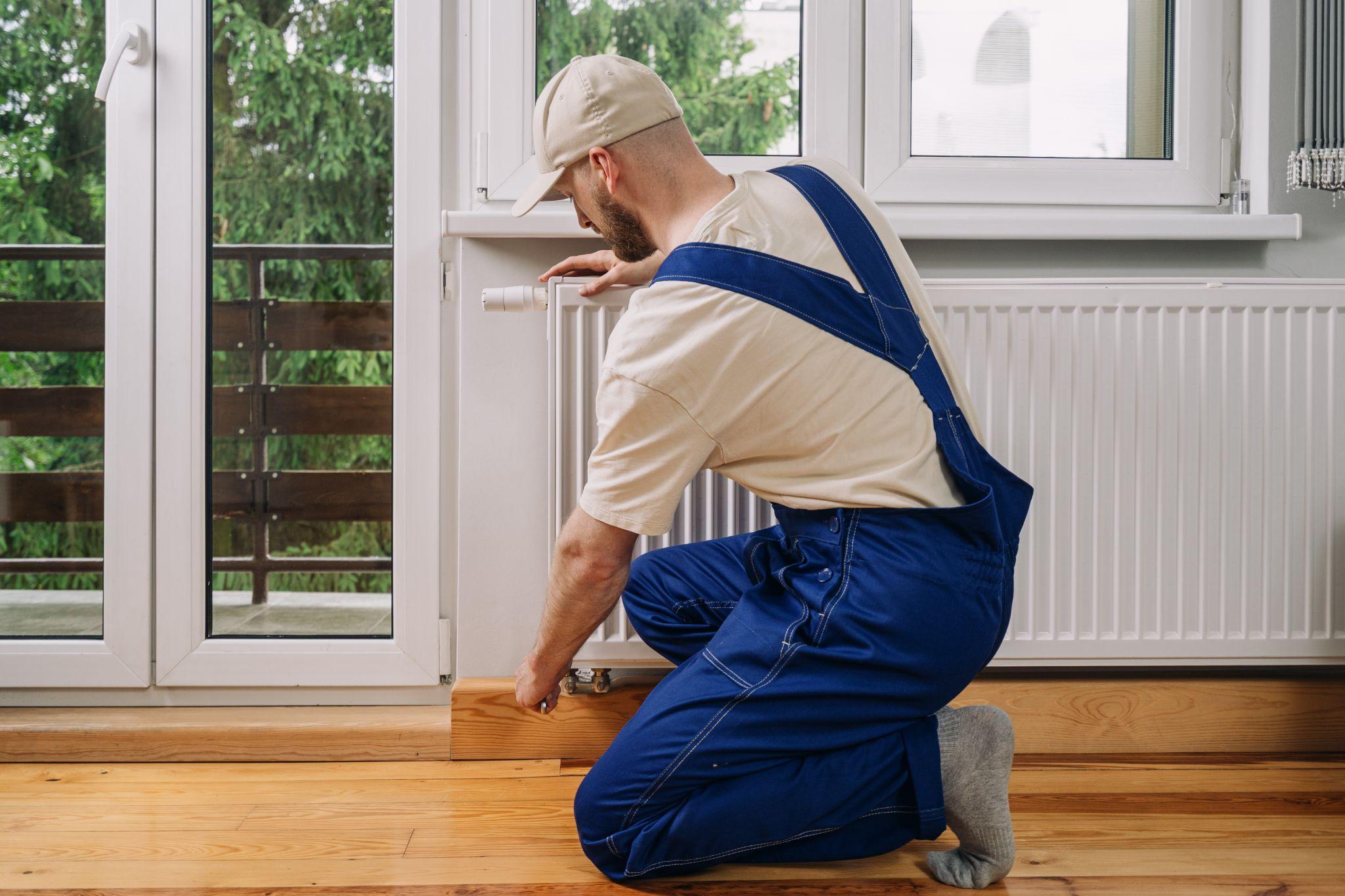 A man repairing a heater