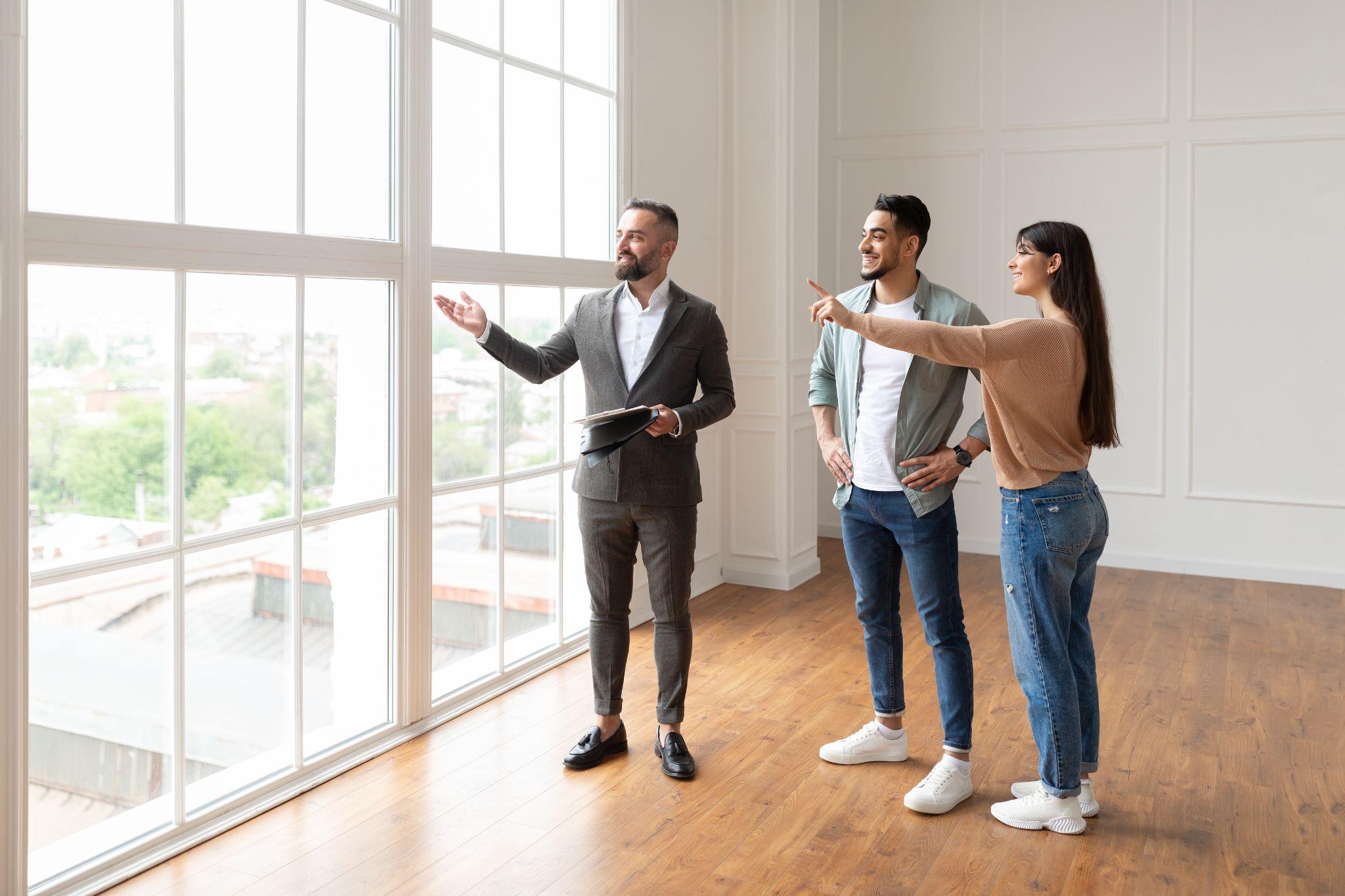 A property manager giving a couple a tour of an empty apartment